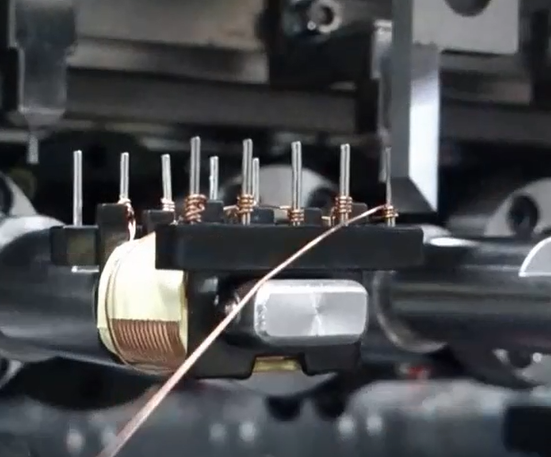 Take a close-up shot of transformer winding machine operation video